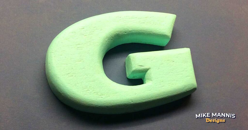 Carved foam Letter G with wood outline.
